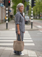 Woman wearing relaxed shirt and trousers two-piece set in a casual, breathable fabric for everyday comfort and style