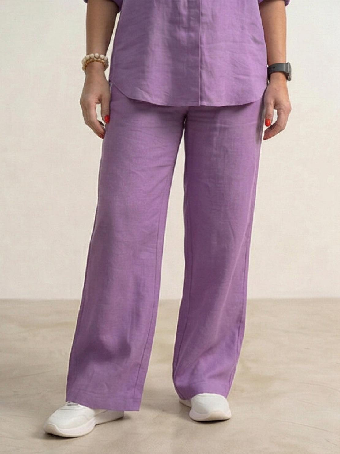Woman wearing a relaxed shirt and trousers two-piece set in soft, breathable fabric.