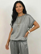 Model wearing Silken Escape Satin Two-Piece Set with wide-leg pants and slim top in elegant satin fabric