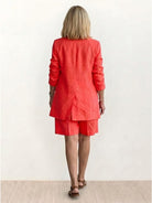 Woman wearing a stylish blazer and shorts two-piece set in vibrant color