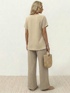 Woman wearing textured elegance two-piece set with asymmetrical top and wide-leg pants in neutral tone