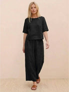 Loose fit black co-ord set with short sleeves and wide-leg pants for relaxed comfort and effortless style