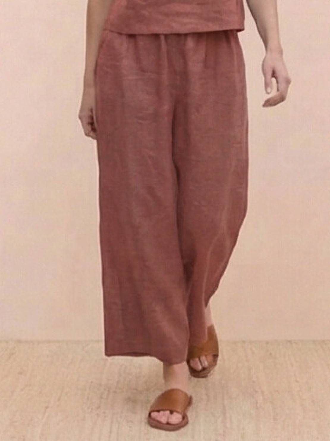Woman wearing a loose fit co-ord set with a soft-tailored top and wide-leg bottoms in a relaxed meadow-inspired style