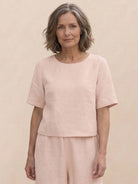 Woman wearing loose fit co-ord set with soft-tailored top and wide-leg bottoms in relaxed style