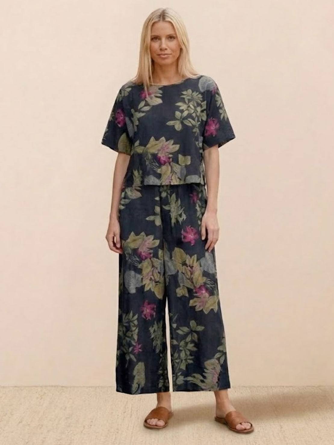 Woman wearing floral loose fit co-ord set with short sleeves and wide-leg pants