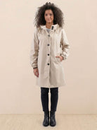 Woman wearing beige Rain Couture Windbreaker with oversized fit and water-resistant fabric.
