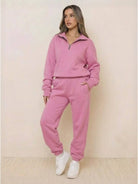 Woman wearing an ultra-soft and comfy pink co-ord tracksuit set with zip-up top and jogger pants.
