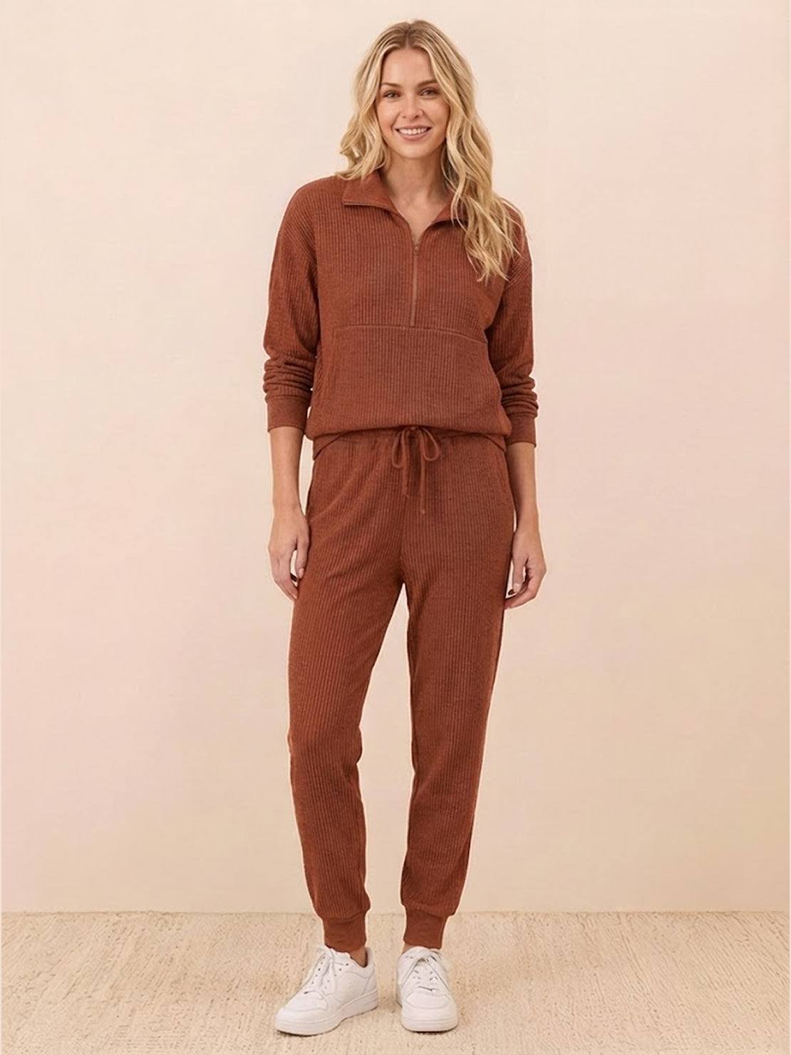 Unisex half-zip pullover and matching sweatpants set in soft fabric for casual wear and travel