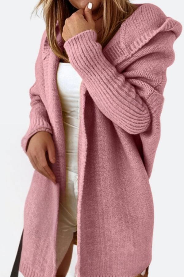Soft pink warm oversized hooded cardigan with ribbed sleeves, styled over white outfit