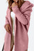 Soft pink warm oversized hooded cardigan with ribbed sleeves, styled over white outfit