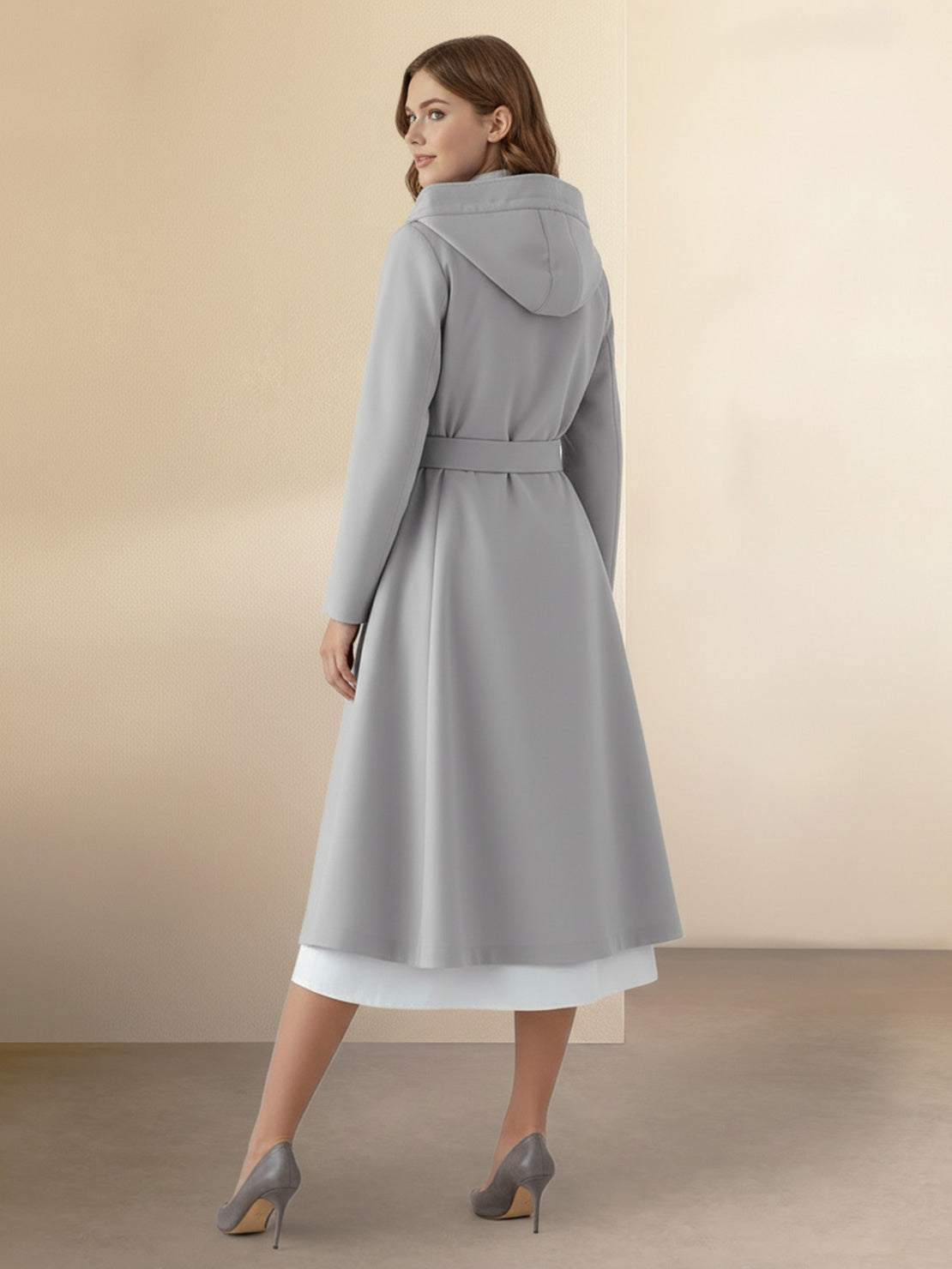 Woman wearing water-repellent rain A-line hooded raincoat with belt, elegant and weather-resistant.