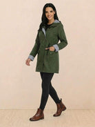 woman wearing green water resistant windbreaker jacket with hood and striped design
