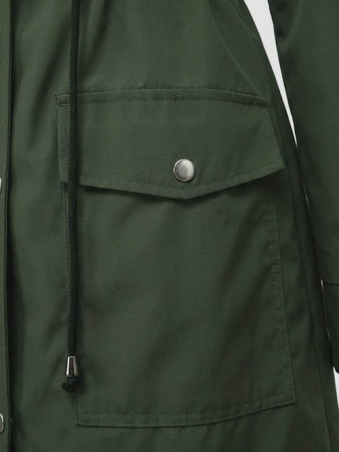 Close-up of green water resistant windbreaker pocket with snap button and drawstring cinch detail