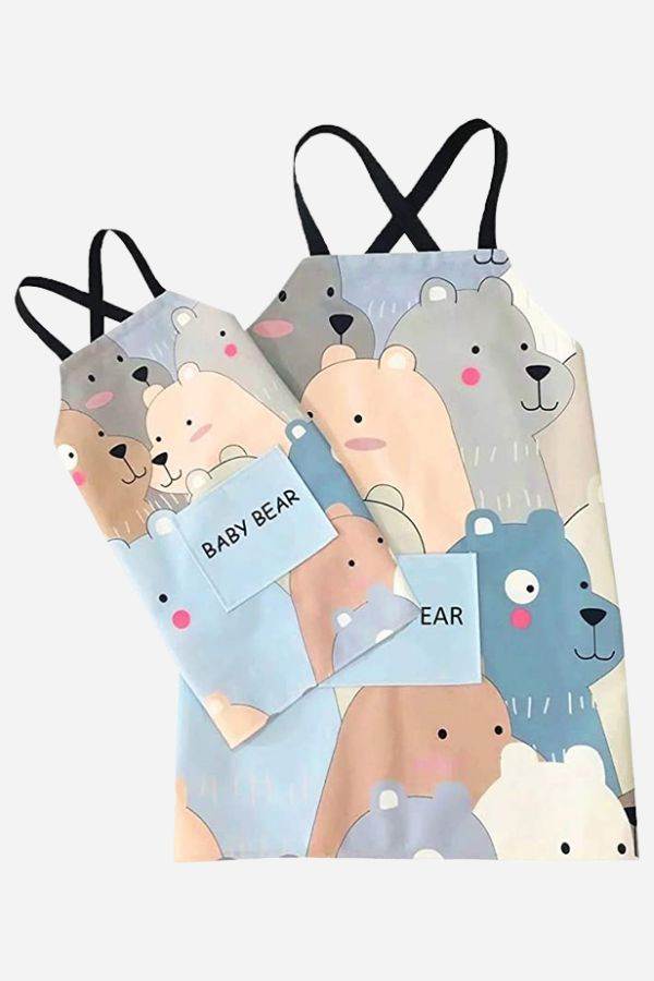 Matching Mommy & Me apron set with cartoon bear pattern, durable cotton linen, oil-proof coating, and convenient front pockets for kitchen use.