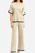 Beige short sleeved relaxed fit lounge two-piece set with black trim on sleeves and pant hems